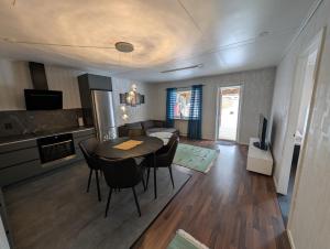 a kitchen and living room with a table and chairs at Villa Vilsam in Gällivare