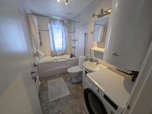 a white bathroom with a sink and a toilet at Villa Vilsam in Gällivare