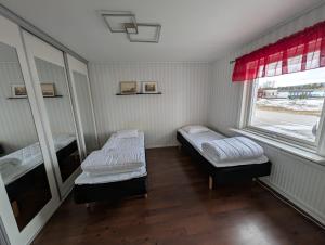 a room with two beds and a window at Villa Vilsam in Gällivare