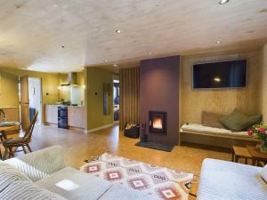 a living room with a couch and a fire place at Hygge House in Woodside