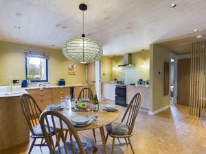 a kitchen and dining room with a table and chairs at Hygge House in Woodside +4 photos