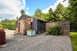 a small house sitting on top of a gravel yard at Hygge House in Woodside