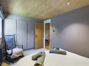 a bedroom with a bed and a chair in a room at Hygge House in Woodside
