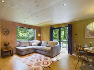 a living room with a couch and a table at Hygge House in Woodside