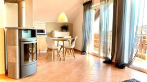 a kitchen and dining room with a table and chairs at Maarträumchen in Gillenfeld in Gillenfeld