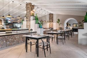 a restaurant with tables and chairs and a bar at Terra Dei Limoni in Noto Marina