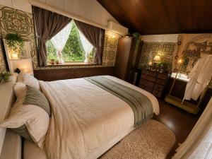 a bedroom with a large bed and a window at Amoria 2 in Miyazaki