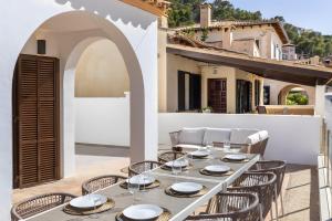 a table and chairs on the patio of a house at Ca Ne Margalide - Andratx in Port d'Andratx