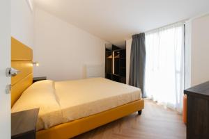 a bedroom with a bed and a large window at Residence Caterina in Cattolica