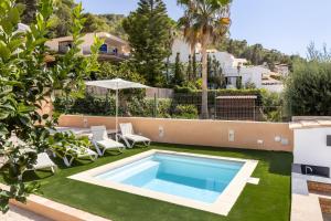 a swimming pool in the yard of a house at Ca Ne Margalide - Andratx in Port d'Andratx