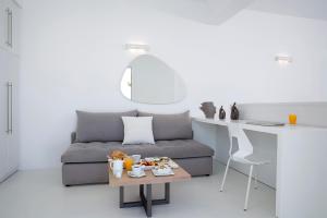 a living room with a couch and a table with food on it at Blue Vice Megalochori in Megalochori