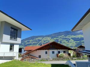 a house with a mountain in the background at EK-Living in Fügen