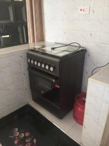 a kitchen with a black stove in a kitchen at Mimi Home Stays in Voi