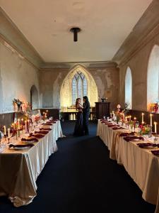 a bride and groom standing in the middle of a row of tables at Shannon River House & Gardens in Limerick
