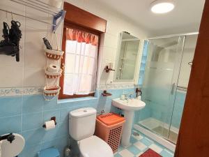 a bathroom with a toilet and a sink and a shower at La torrevia in Santillana del Mar