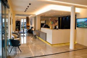 a lobby of a hotel with a bar and chairs at Hotel Asgard's Meereswarte in Zinnowitz +52 photos