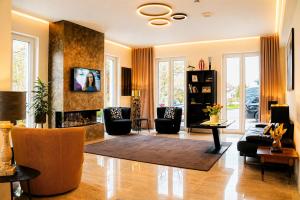 a living room with a couch and a fireplace at Hotel Asgard's Meereswarte in Zinnowitz