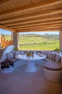 a patio with a white table and a couch at Mystic Horizon in Mikonos