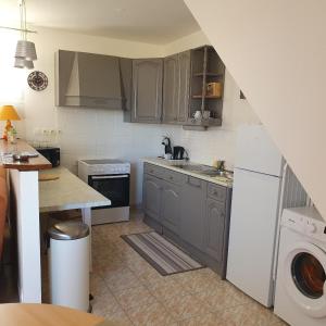 a kitchen with a sink and a dishwasher at Le Gîte Les Grives in Villers-Carbonnel