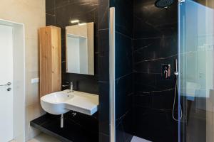 a bathroom with a sink and a shower at Residence Caterina in Cattolica +29 photos