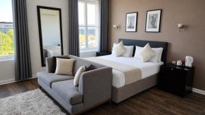 a bedroom with a large bed and a couch at Park Hotel & Apartments in Hull