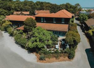 an overhead view of a large house with trees at La Maison du Bassin in Cap-Ferret