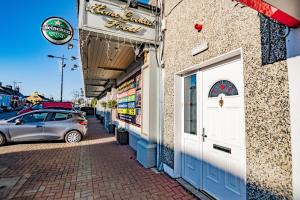 a car parked in front of a building with a door at Flexistays - Private En-Suite Studios - Kinnegad in Kinnegad
