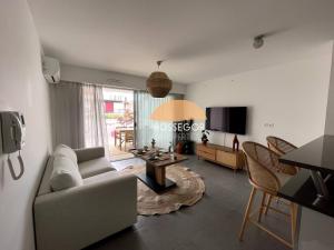 a living room with a couch and a table at Le Clos Brémontier in Soorts-Hossegor