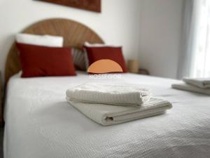 two towels sitting on top of a bed at Le Clos Brémontier in Soorts-Hossegor
