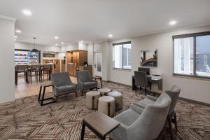 a waiting room with chairs and tables in a building at Candlewood Suites Mobile-Downtown by IHG in Mobile