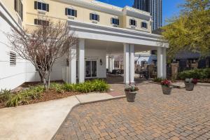 a white house with a brick walkway in front at Candlewood Suites Mobile-Downtown by IHG in Mobile