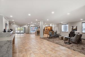 an empty lobby with chairs and tables in a building at Candlewood Suites Mobile-Downtown by IHG in Mobile