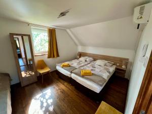 a small bedroom with a bed and a window at Akácos Tanya Szarvas in Szarvas