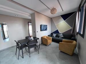 a living room with a table and a couch at Appartement 3 vue sur mer in Tamraght Ou Fella +36 photos