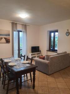 a living room with a table and a couch at B&B Luna in Sesto Calende