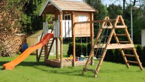 a playground with a slide and a play house at Ferienhaus am Mühlteich in Neuhaus-Schierschnitz