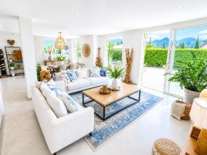a living room with two white couches and a coffee table at Villa Del Sol with Mountain Views in Vence