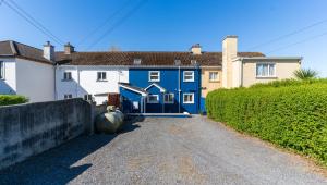 a blue house on a dirt road at Mariner's Rest - Cahersiveen in Cahersiveen