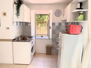 a kitchen with a white refrigerator and a window at CiroMenotti62 in Marina di Carrara +26 photos