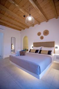 a bedroom with a large bed with a wooden ceiling at Mystic Horizon in Mikonos +136 photos