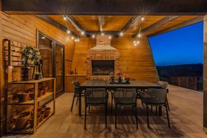 a dining room with a table and chairs and a fireplace at Kuća za odmor Kiara - bazen, jacuzzi i sauna in Karlovac