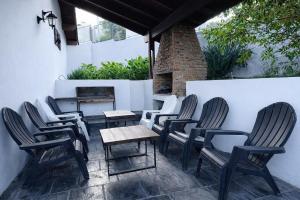 a group of chairs and tables on a patio at Comfortable house in La Falda in La Falda