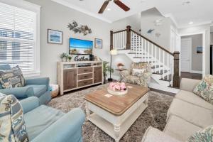 a living room with a couch and a table at Beachful Bliss in Santa Rosa Beach