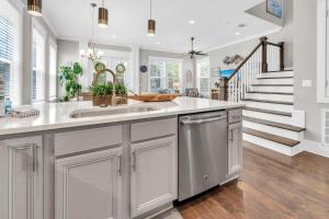 a kitchen with a sink and a staircase at Beachful Bliss in Santa Rosa Beach