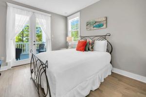 a bedroom with a large white bed and a window at Beachful Bliss in Santa Rosa Beach +66 photos