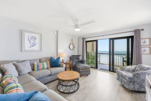 a living room with a couch and chairs and a table at Sandy Bits Oceanfront Premium Condo with Pool in Myrtle Beach