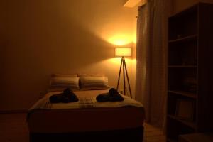 a bedroom with a bed with two towels on it at Hidden gem agora flat Checkpoint-Mytilene in Mytilene