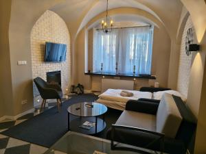 a living room with a bed and a couch at Apartament Florian Rynek 3 in Radków