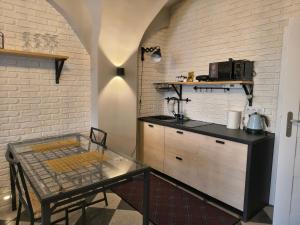 a kitchen with a counter and a table in a room at Apartament Florian Rynek 3 in Radków