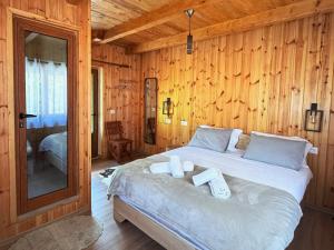 a bedroom with a bed with two towels on it at Vila Shkalla in Theth